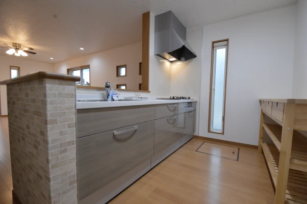 レンガ柄と木目調の対面キッチン